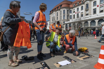 vier Personen mit Warnweste zwei Frauen stehen und zwei Frauen knien 