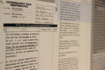 Ausschnitt eines Blattes auf dem ein Protokoll mit Schreibmaschine niedergeschrieben wurde.