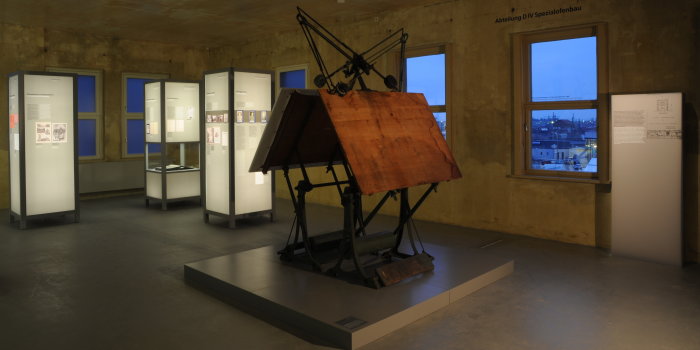 Two historical drafting machines in the center of the image