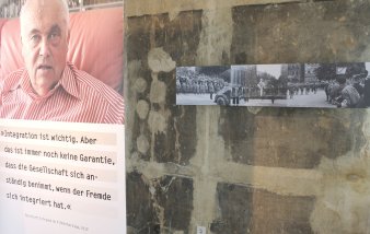 Farbfoto, links Banner mit Foto eines alten Mannes, unter dem Foto Schriftzug Integration ist wichtig. Aber das ist immer noch keine Garantie, dass die Gesellschaft sich anständig benimmt, wenn der Fremde sich integriert hat Reinhard Schramm im Videointerview 2012rechts im Bild mehrere Schwarz-Weiß-Fotos an der Wand